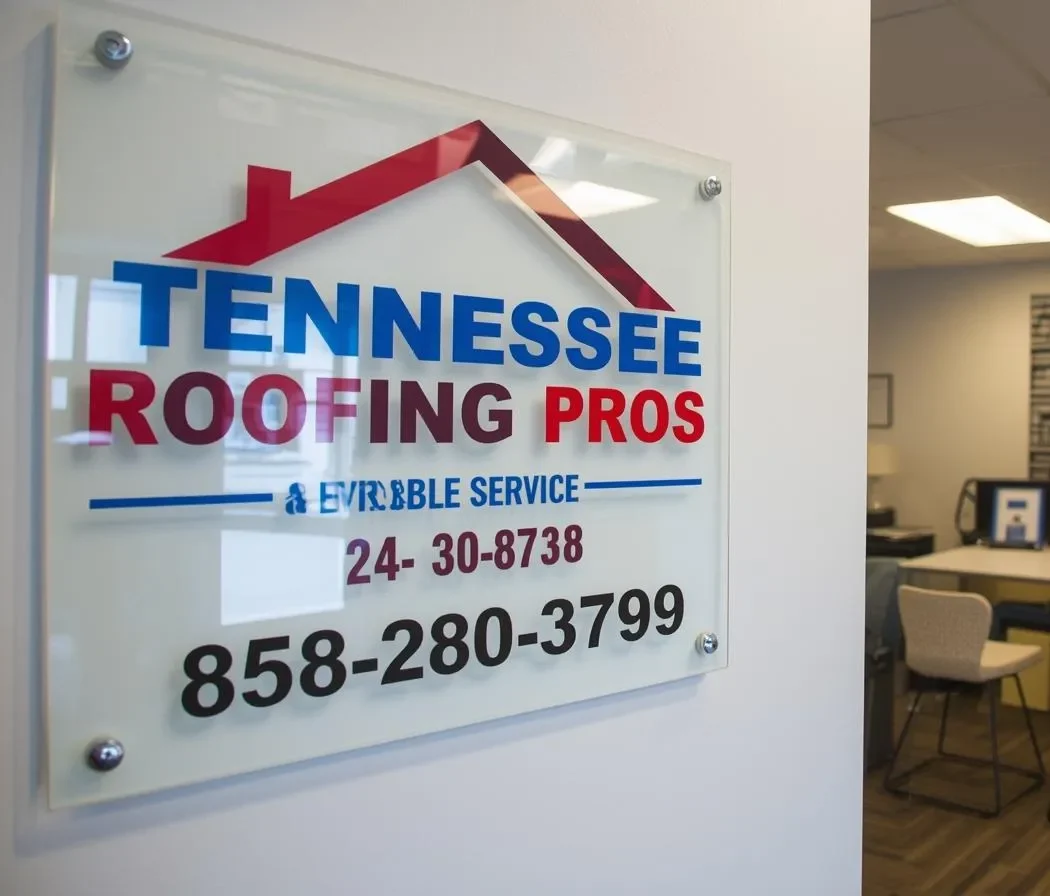 Workers securing tarp over leaking roof on house at night in heavy rain